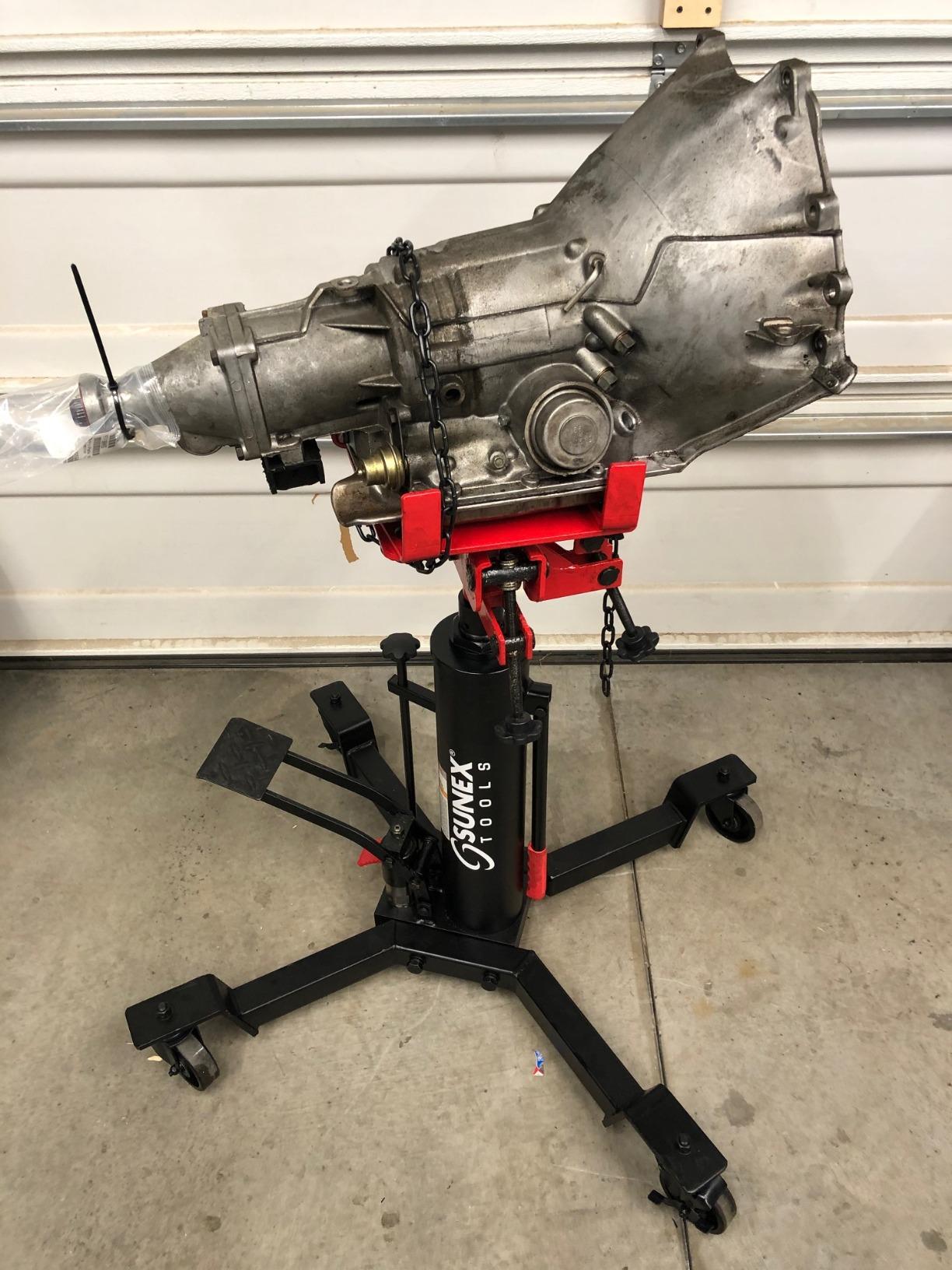 Sunex Tools 7793B 1,000 lb Telescopic Transmission Jack, Hydraulic, Foot Pump Operated, Tilt Saddle with Chain Tie-Down, 74.2 in Max Height customer photo 1